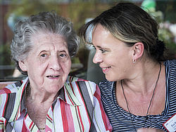Seniorin und ihre Angehörige sprechen miteinander